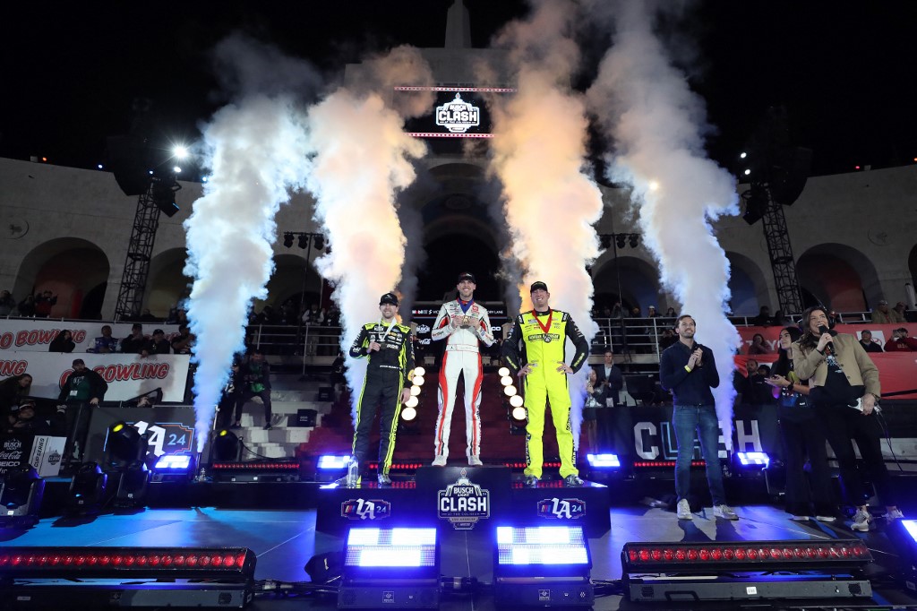 Denny Hamlin, driver of the #11 Sport Clips Haircuts Toyota, winner and others pose
