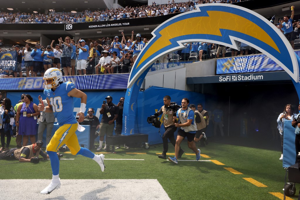 Justin Herbert of the Los Angeles Chargers runs onto the field before his team's game against the Las Vegas Raiders, and we offer new U.S. bettors our exclusive BetRivers promo code for NFL Week 6.