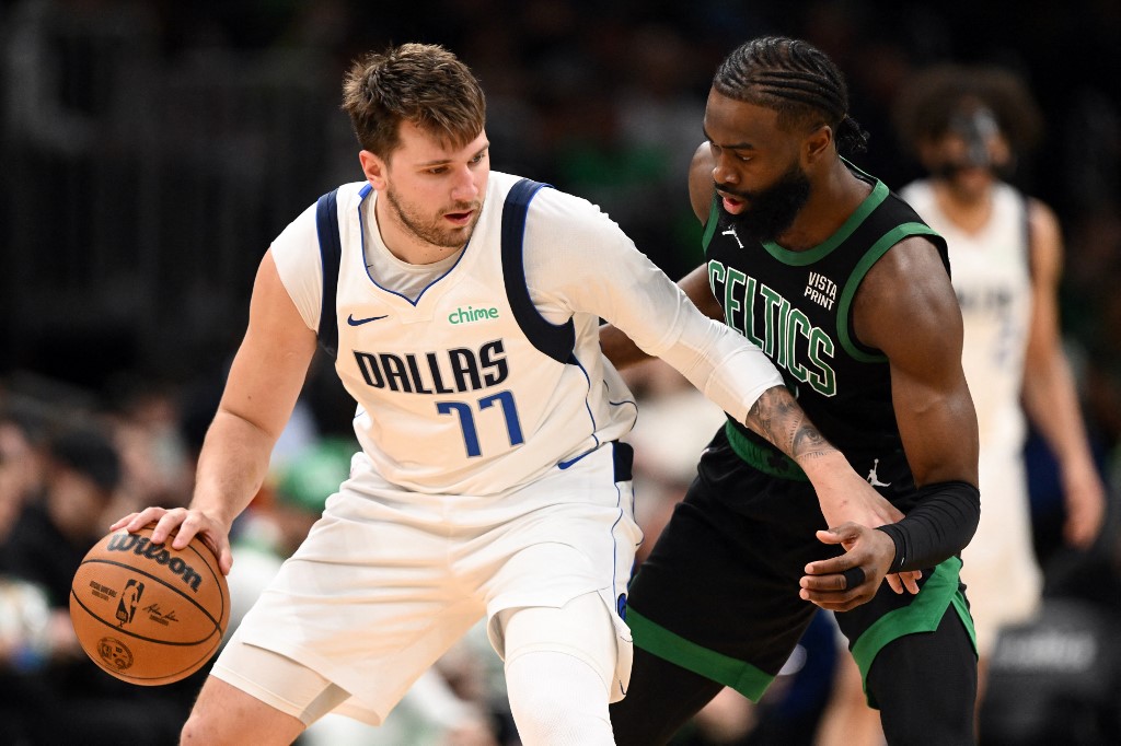 Jaylen Brown (7) of the Boston Celtics defends Luka Doncic (77) of the Dallas Mavericks, as we offer our best NBA Final expert picks for Mavericks vs. Celtics in the 2024 NBA Finals.