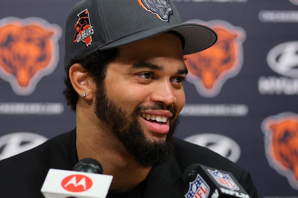 Chicago Bears QB Caleb Williams (18) answers a question during his introductory press conference, as we examine the 2024 NFL rookie passing leader odds with Williams as the betting favorite.