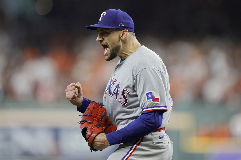 Nathan Eovaldi of the Texas Rangers celebrates an out against the Houston Astros, and we offer our top predictions for Game 1 of the World Series between the Diamondbacks and Rangers based on the best MLB odds.