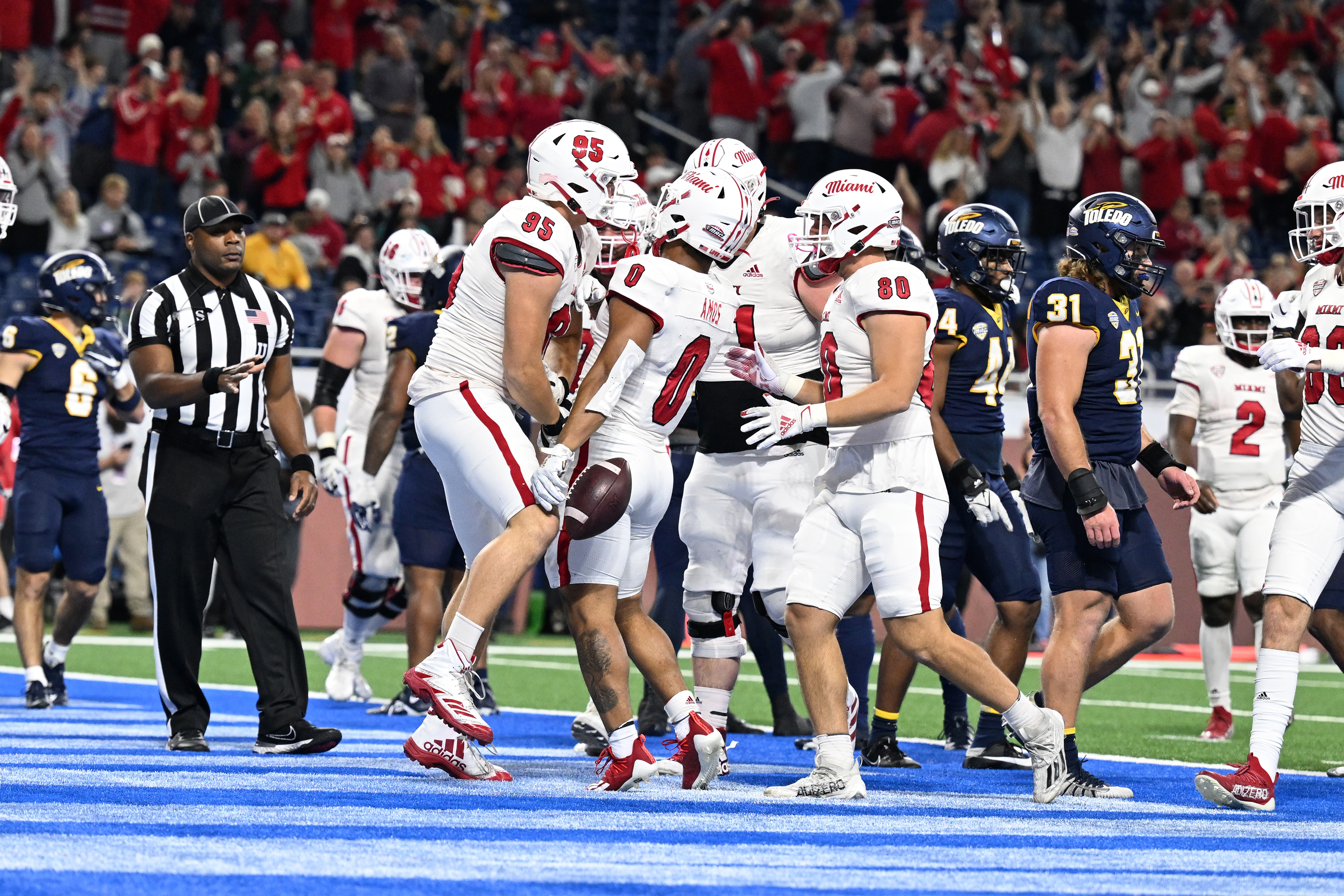 Miami (OH) Redhawks running back Rashad Amos celebrates in the end zone after running for a touchdown against the Toledo Rockets in the MAC Championship Game. Miami (OH) leads the 2024 MAC Championship Odds.