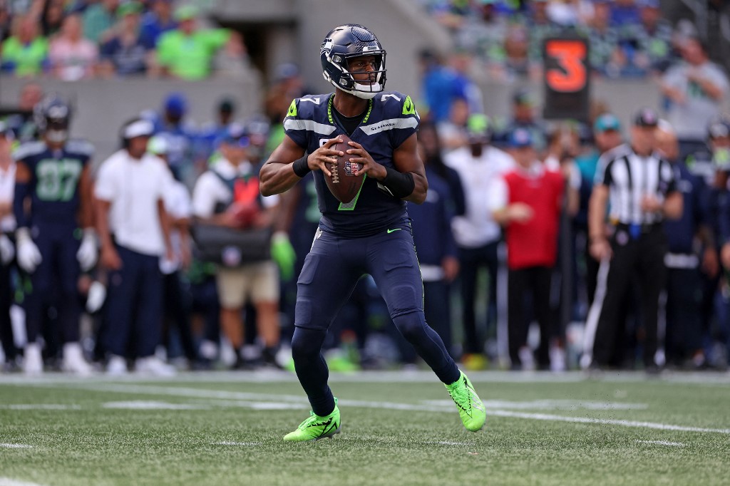 Geno Smith #7 of the Seattle Seahawks attempts a pass as we look at our NFL expert picks for Week 2