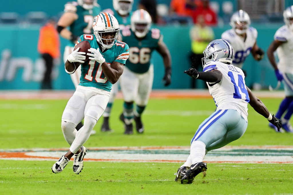 Tyreek Hill of the Miami Dolphins runs after a catch while defended by Markquese Bell of the Dallas Cowboys, and we offer our top Tyreek Hill player props based on the best NFL odds.