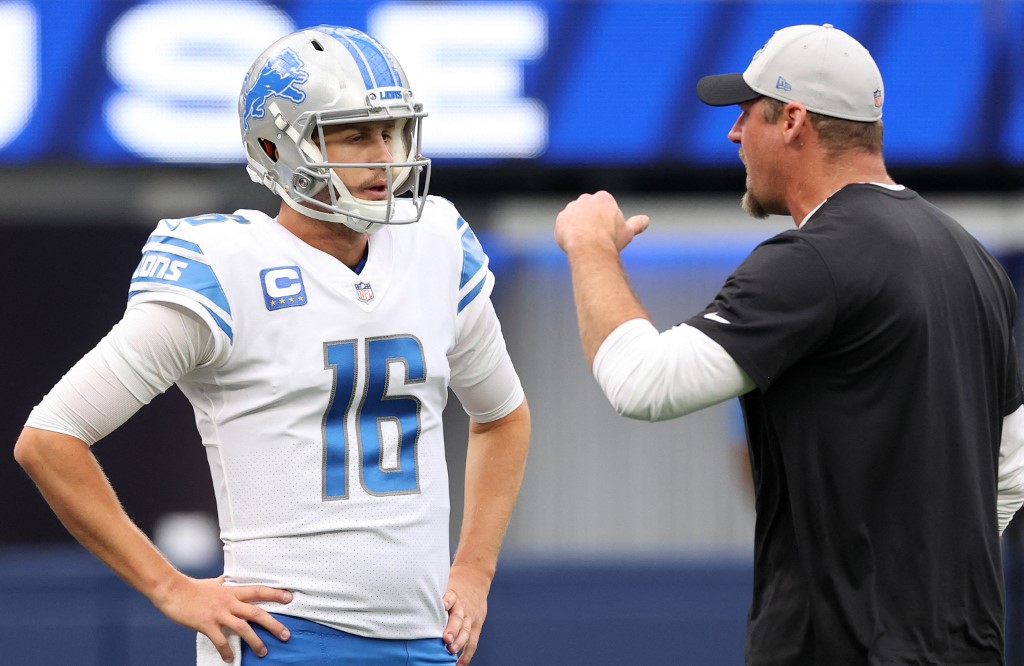 Jared Goff of the Detroit Lions talks to head coach Dan Campbell as we share our top Lions vs. Raiders MNF prediction.