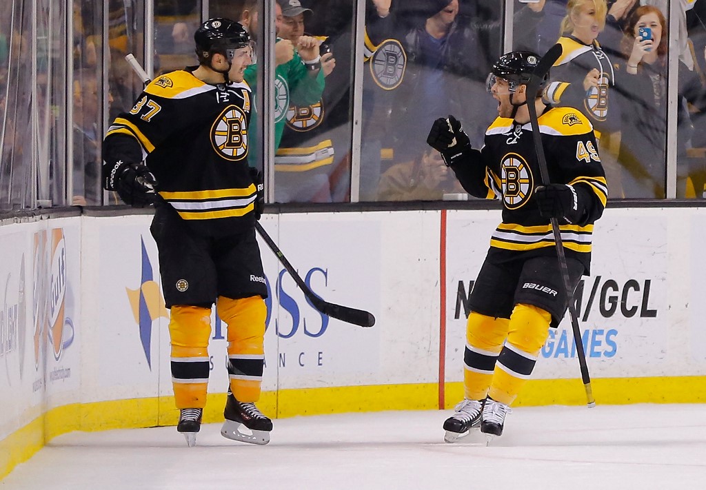 Patrice Bergeron of the Boston Bruins celebrates with teammate David Krejci after scoring a goal against the Montreal Canadiens.
