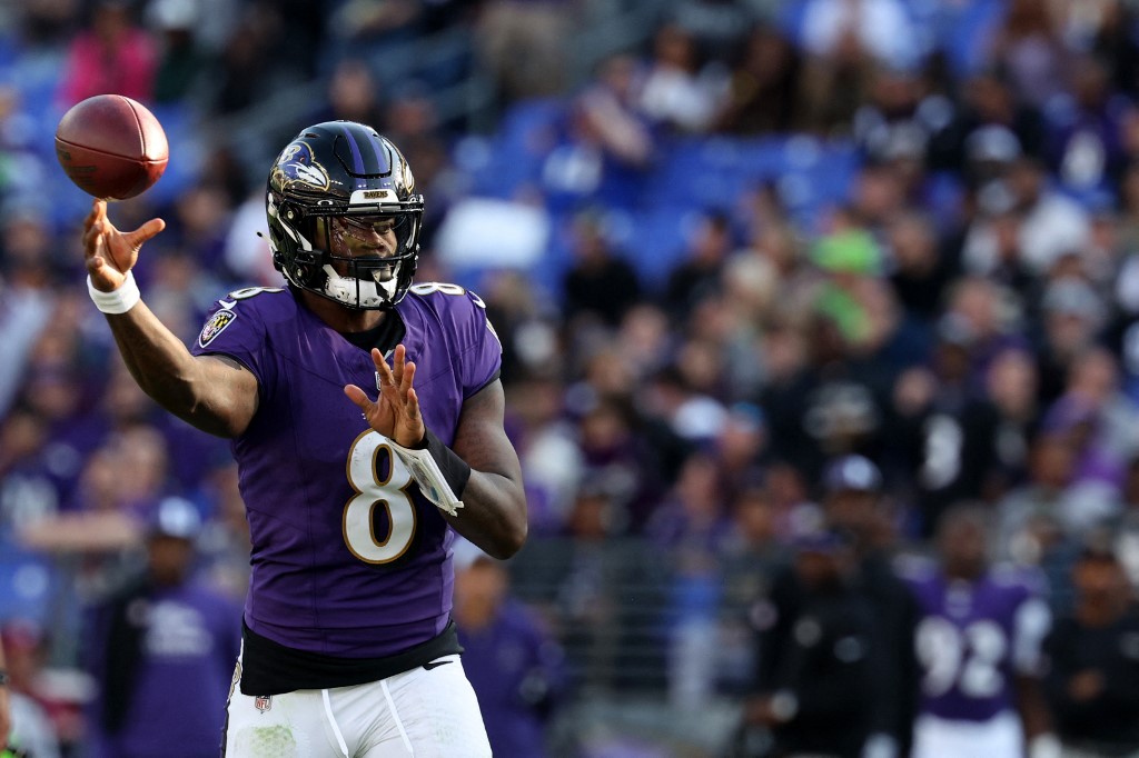 Lamar Jackson of the Baltimore Ravens throws a pass as part of our Week 10 NFL predictions for Browns vs. Ravens