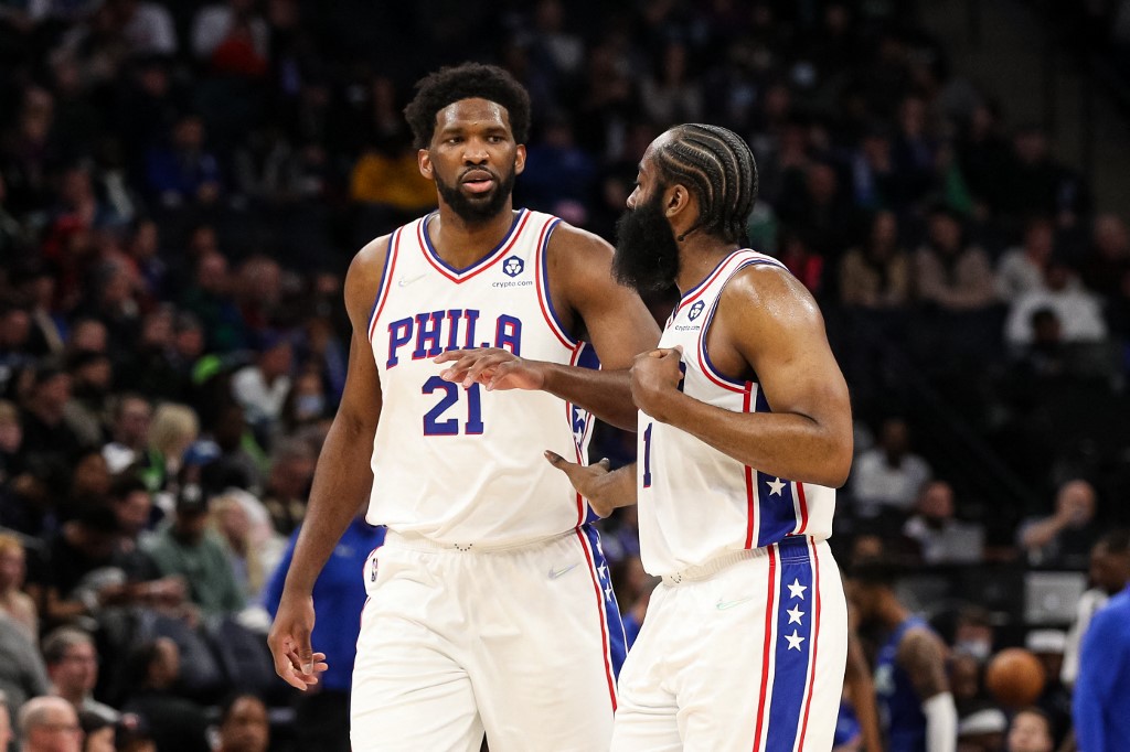 Joel Embiid #21 celebrates with James Harden #1 of the Philadelphia 76ers after making a basket against the Minnesota Timberwolves in the fourth quarter of the game at Target Center on Feb. 25. 
