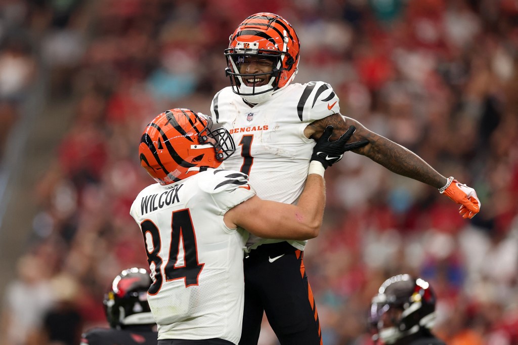 Mitchell Wilcox lifts up Ja'Marr Chase of the Cincinnati Bengals after a touchdown catch against the Arizona Cardinals as we look at our Ja'Marr Chase NFL player prop picks.