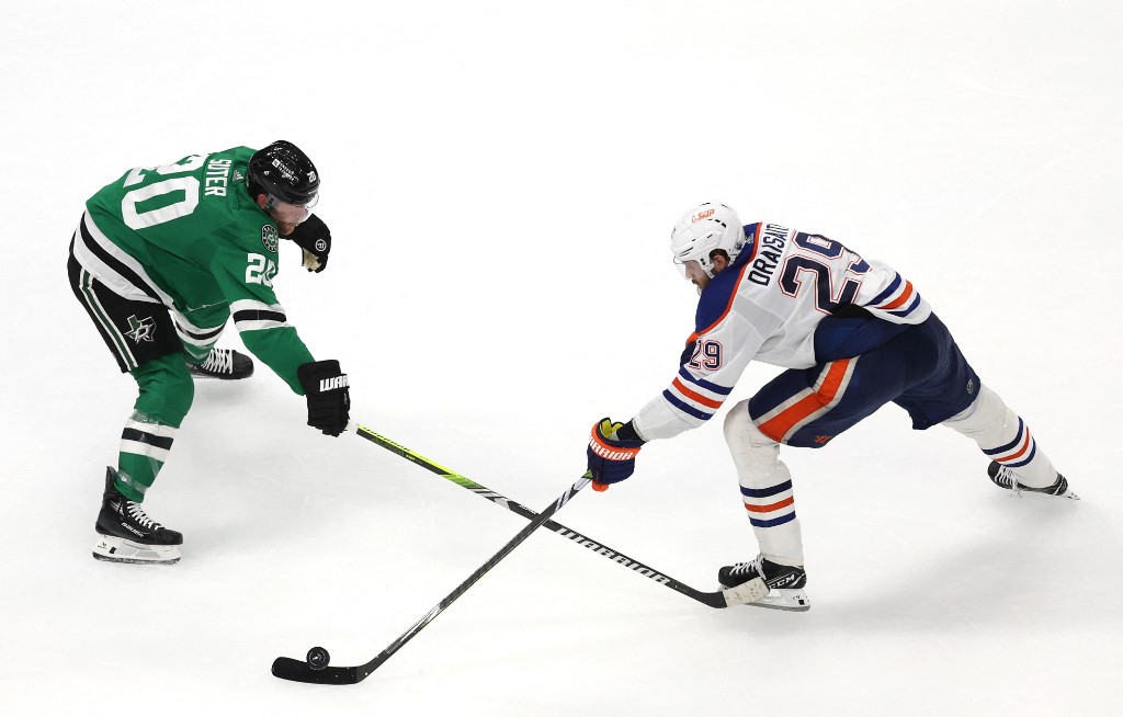 Ryan Suter of the Dallas Stars defends Leon Draisaitl of the Edmonton Oilers during overtime in Game 1 of the Western Conference Final of the 2024 Stanley Cup Playoffs. We're backing Draisaitl in our Stars vs. Oilers Predictions.