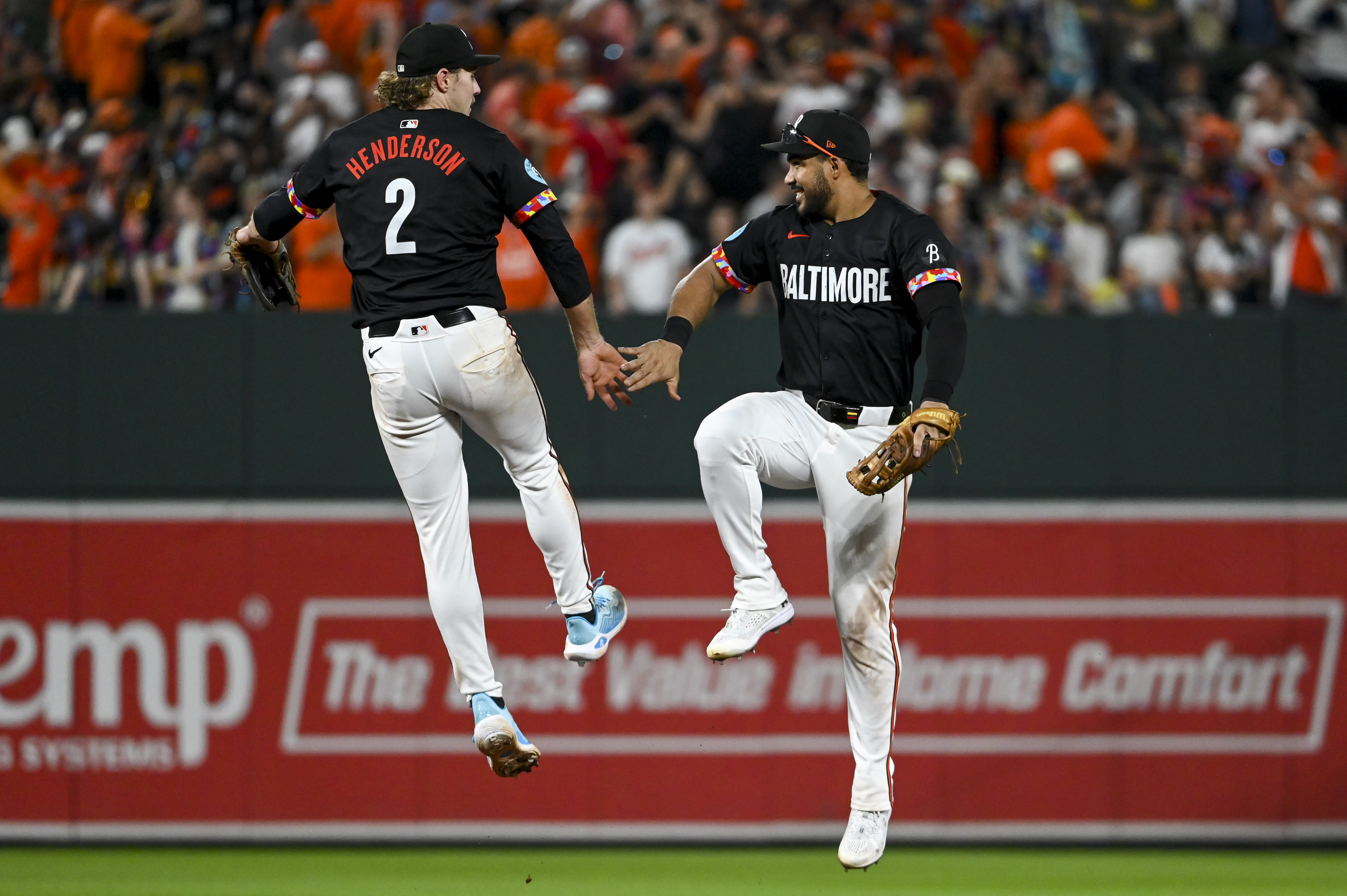 Baltimore Orioles shortstop Gunnar Henderson (2) and outfielder Anthony Santander (25) celebrate as we offer our best Rangers vs. Orioles player props and expert picks for Sunday Night Baseball at Camden Yards in Baltimore.