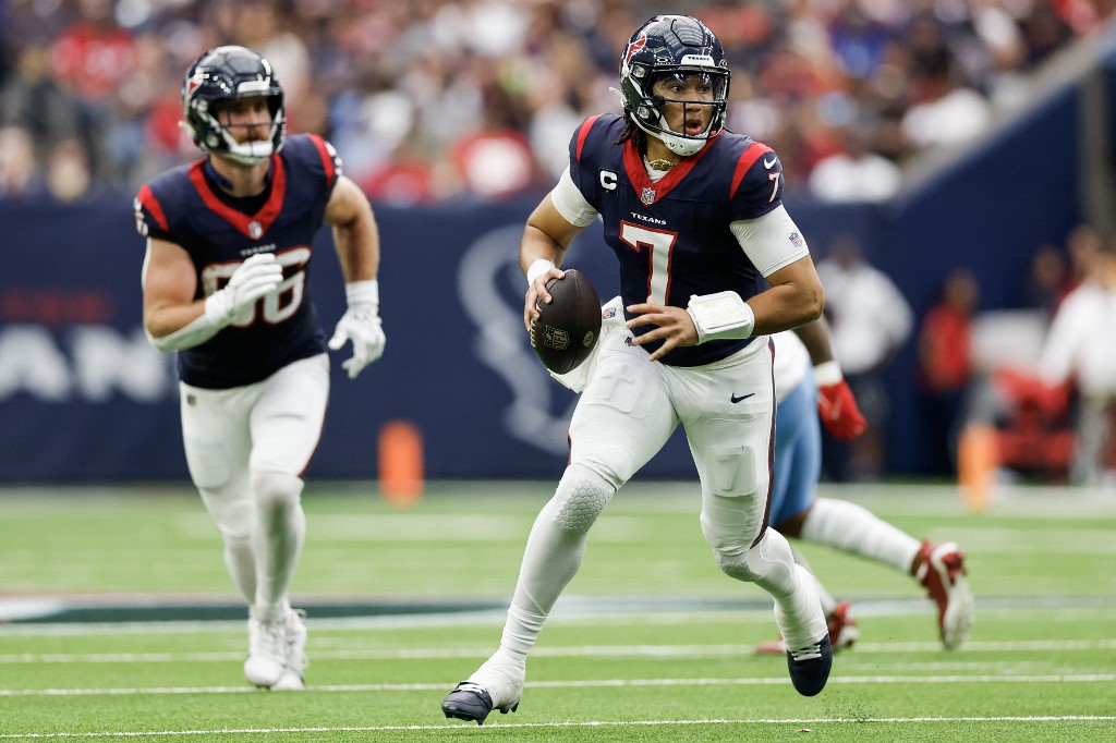 C.J. Stroud of the Houston Texans runs with the ball ahead of our Week 18 NFL predictions for Texans vs. Colts.