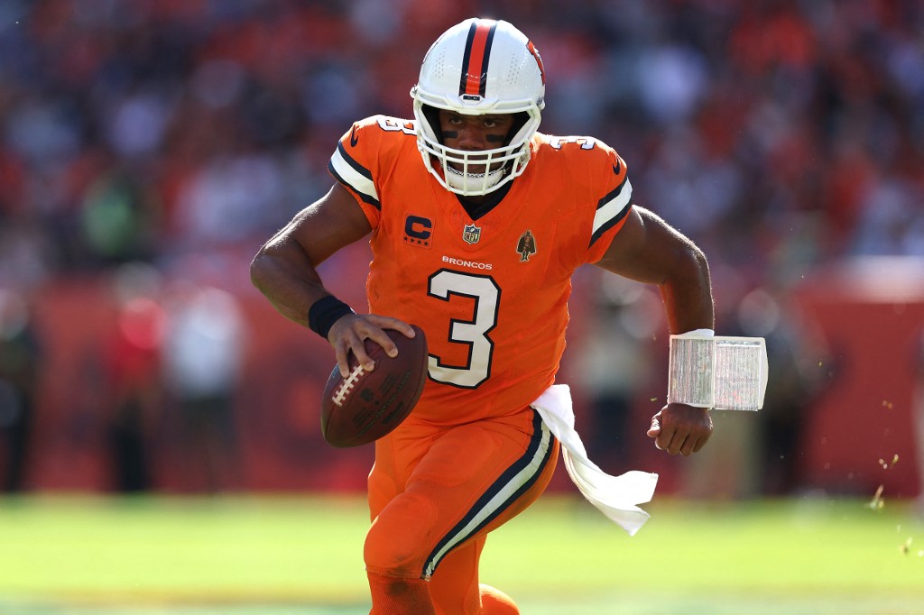 Russell Wilson #3 of the Denver Broncos runs with the ball in the first quarter as we make our Broncos vs. Chiefs prediction