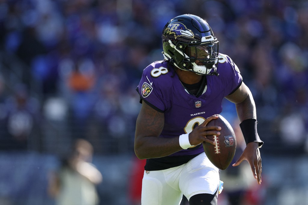 Quarterback Lamar Jackson of the Baltimore Ravens rushes with the ball as we look at our Bengals-Ravens bonus code.