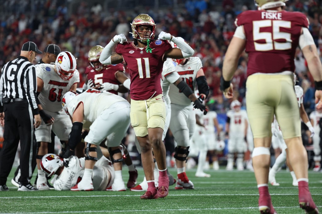 Patrick Payton of the Florida State Seminoles reacts after Braden Fiske sacks Jack Plummer of the Louisville Cardinals during ACC Championship. Florida State opened as the favorites by the 2024 ACC Championship Odds.