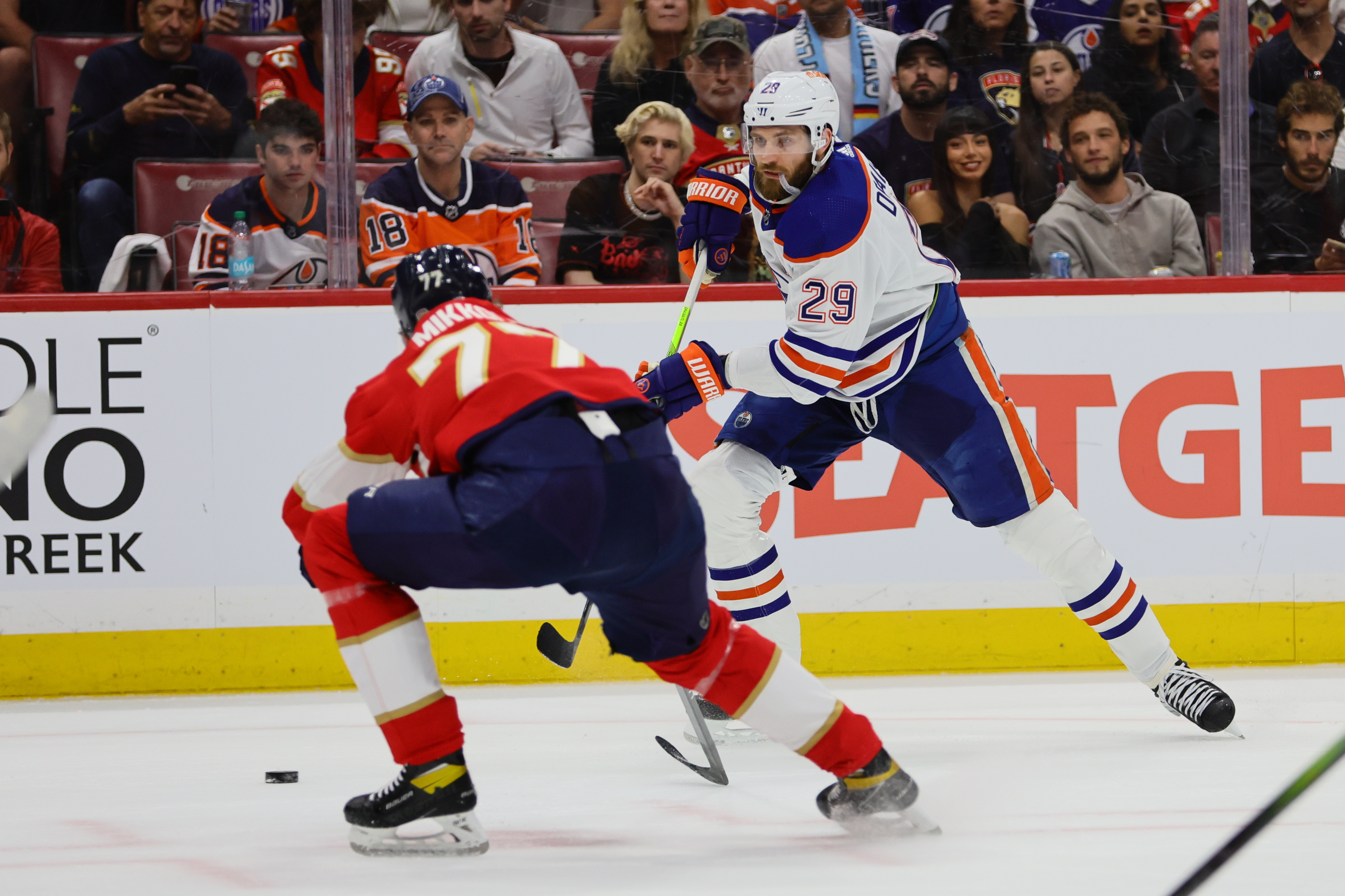 Edmonton Oilers forward Leon Draisaitl passes the puck against Florida Panthers defenseman Niko Mikkola in Game 1 as Gonzales Oona explores his best Oilers vs. Panthers Parlay.