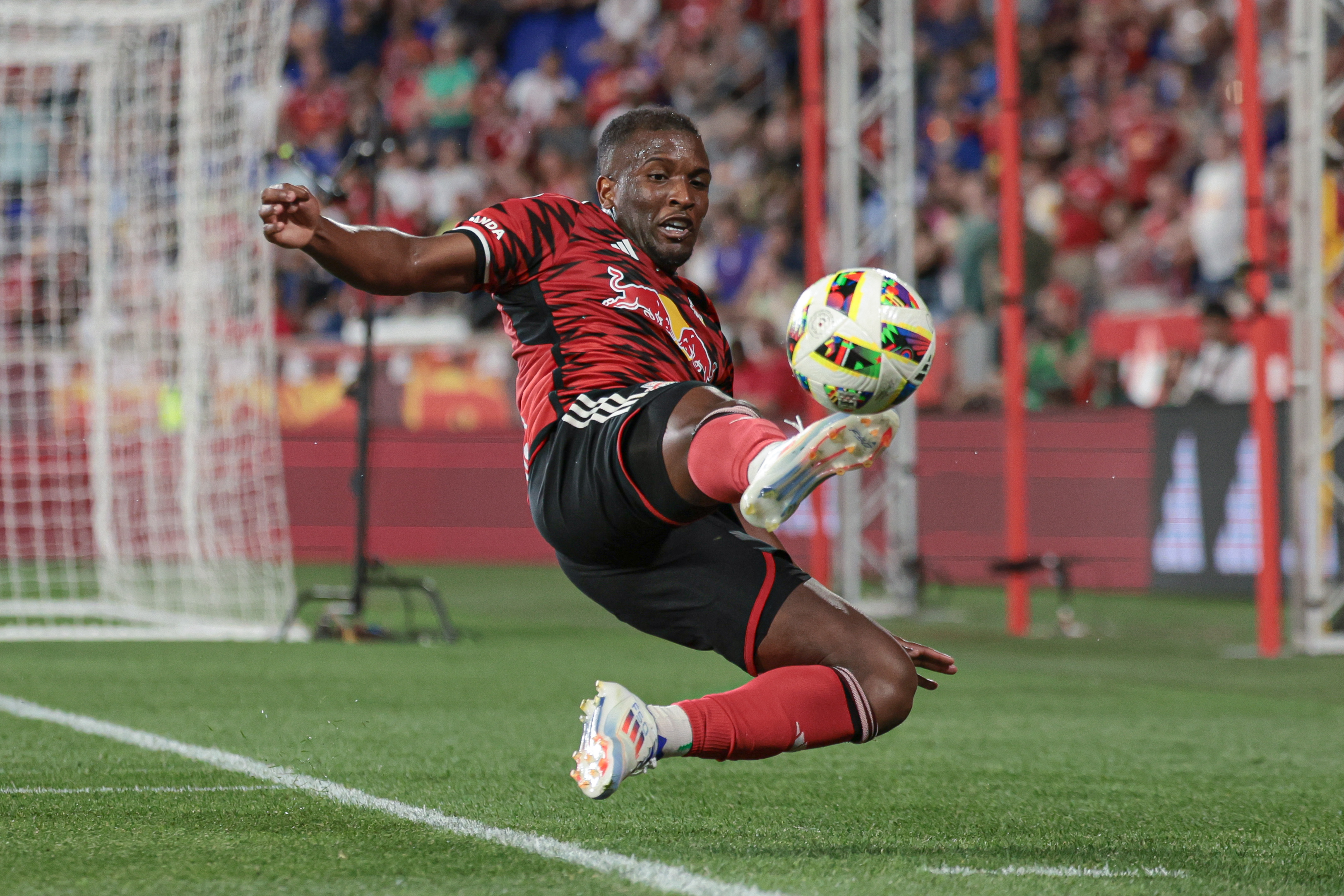 New York Red Bulls forward Elias Manoel (11) attempts to keep the ball in play as we explore the New Jersey sports betting revenue report for May 2024.