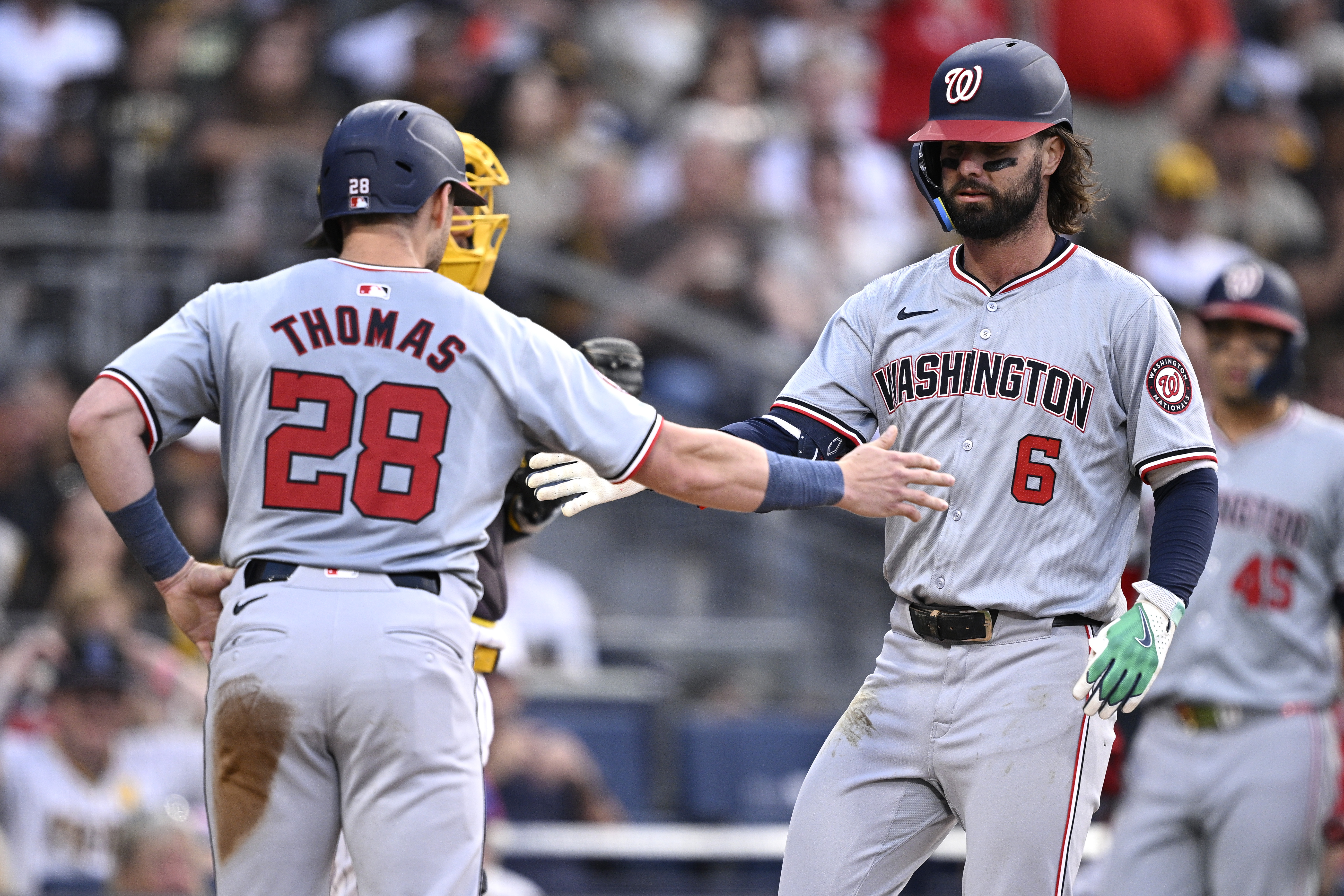 Washington Nationals left fielder Jesse Winker is congratulated by right fielder Lane Thomas as we look at the details of the DC Council approving its 2025FY budget.