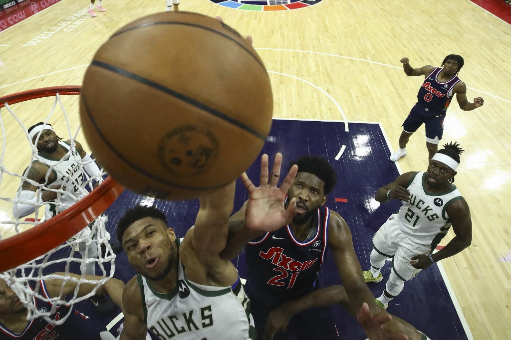 Giannis Antetokounmpo of the Milwaukee Bucks attempts to block a shot by Joel Embiid of the Philadelphia 76ers during the third quarter at Wells Fargo Center on March 29, 2022 in Philadelphia, Pennsylvania.