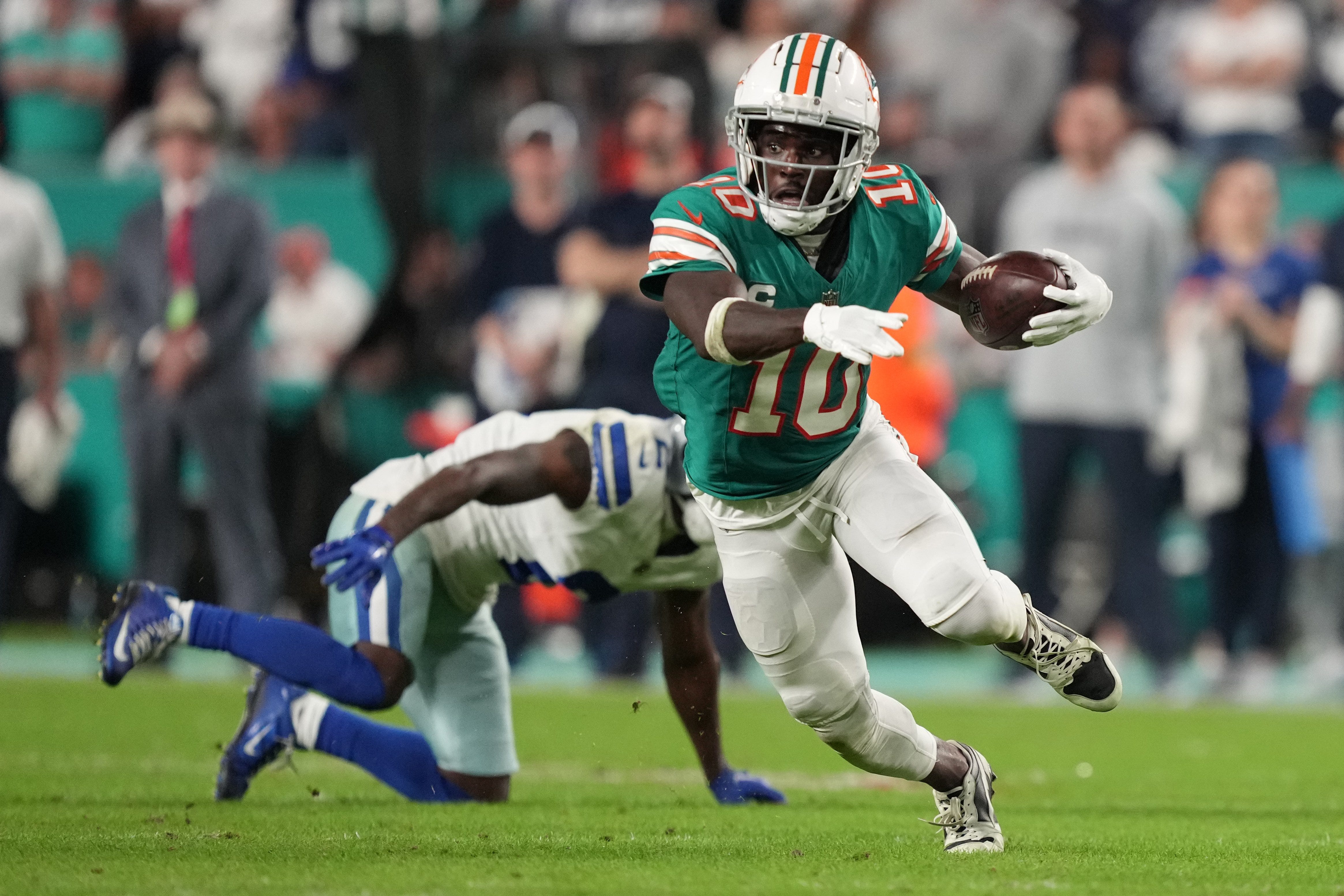 Miami Dolphins wide receiver Tyreek Hill picks up a first down on the Dolphins final drive that lead to a game-winning field goal against the Dallas Cowboys. Hill leads the 2024-25 NFL Offensive Player of the Year Odds.