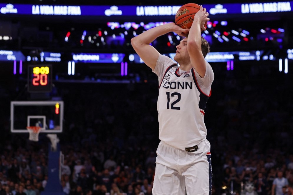 Cam Spencer of the Connecticut Huskies attempts a three-point shot as we look at the latest Connecticut industry news concerning Fanatics.