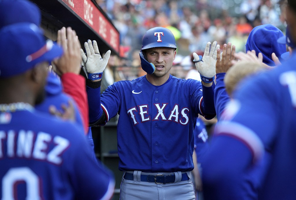 Corey Seager of the Texas Rangers is congratulated by teammates after he hit a solo home run against the San Francisco Giants as we look at the BetMGM promo code for Diamondbacks-Ranger.