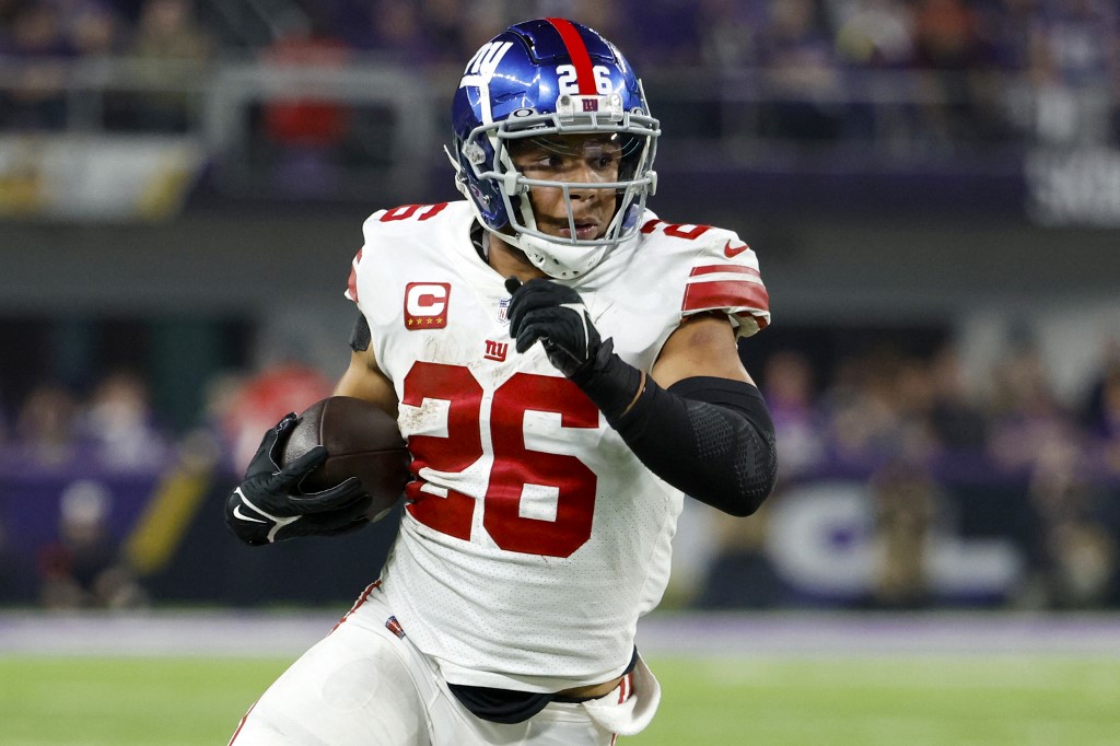 Saquon Barkley of the New York Giants rushes during the fourth quarter against the Minnesota Vikings as we look at our Week 2 NFL parlay predictions.