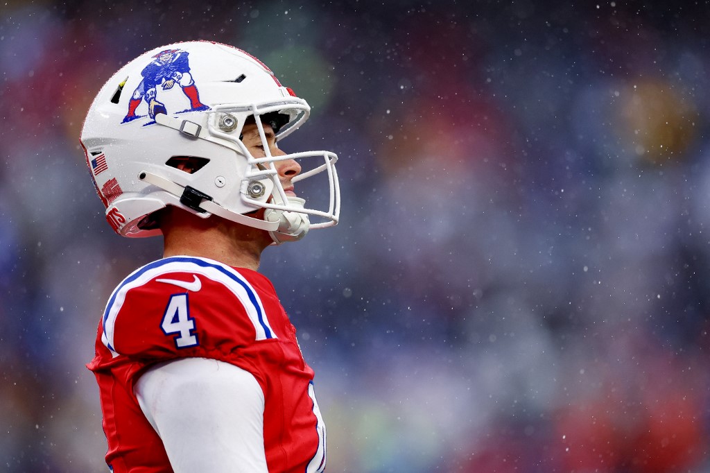Bailey Zappe of the New England Patriots walks across the field in the second quarter against the Los Angeles Chargers, and we offer our top Patriots vs. Broncos prediction based on the best NFL odds.