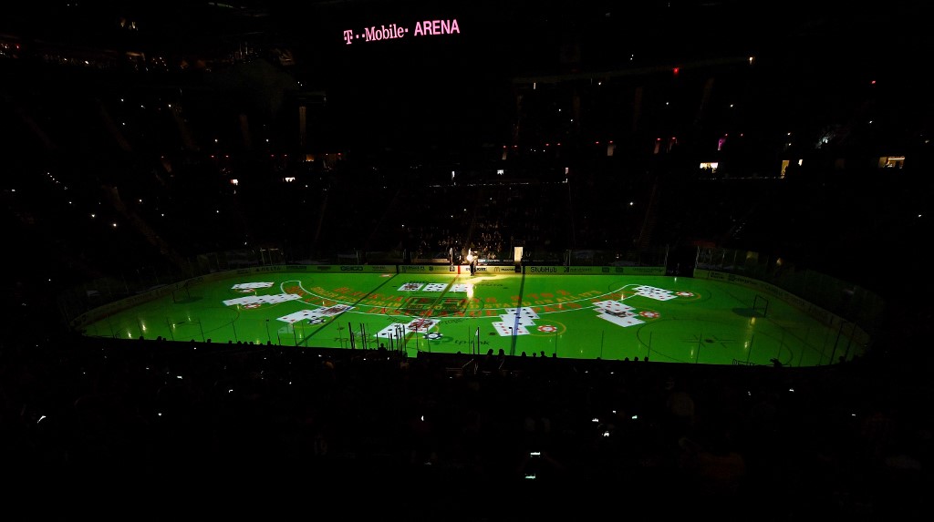 An image of a blackjack table is projected on the ice as we look at Caesars blackjack partnership with the NHL
