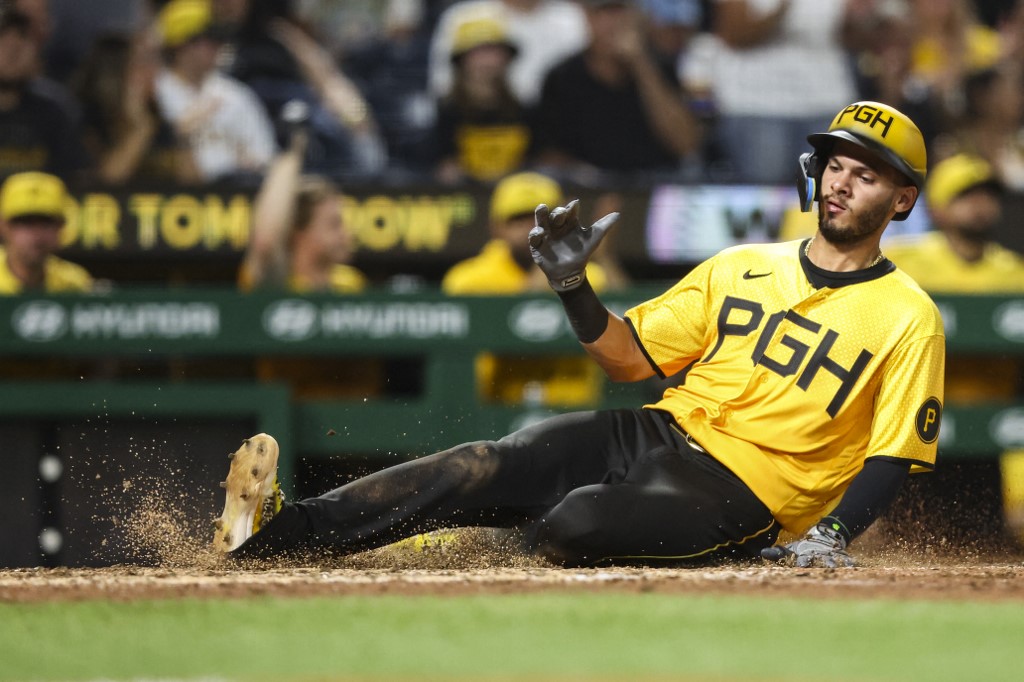 Tucupita Marcano of the Pittsburgh Pirates slides across home plate to score.