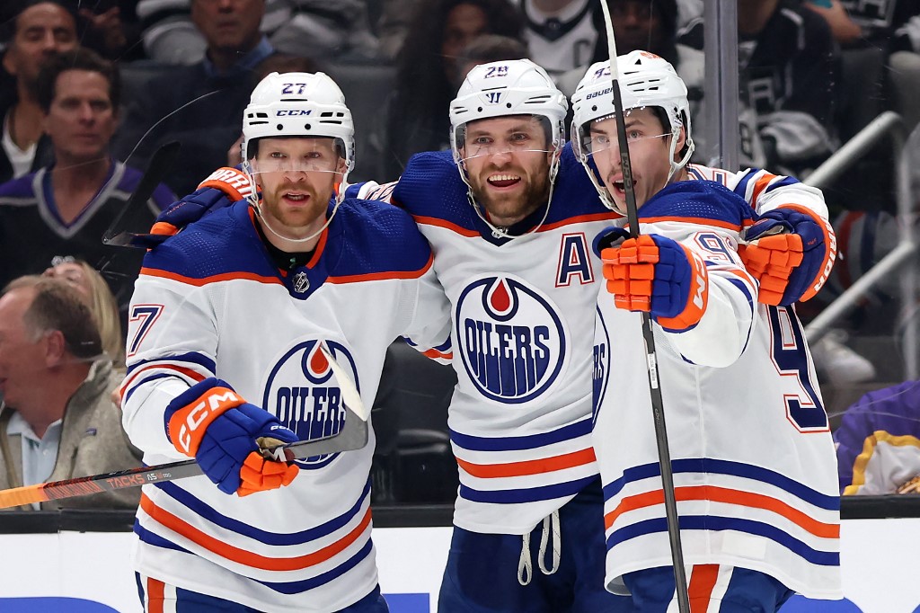 Ryan Nugent-Hopkins and Brett Kulak congratulate Leon Draisaitl of the Edmonton Oilers after his goal against the Los Angeles Kings, and we offer our top Oilers vs. Kings predictions and expert picks based on the best NHL odds.