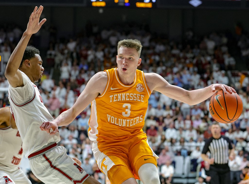Dalton Knecht #3 of the Tennessee Volunteers drives to the basket during the first half against Rylan Griffen #3 as we make our best March Madness MVP predictions. 